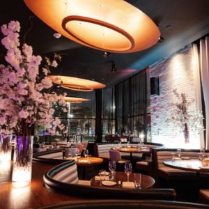 Booth tables, lamp and flower decorations at STK Restaurant