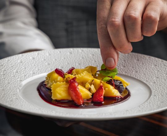 Chef holding dish at 1919