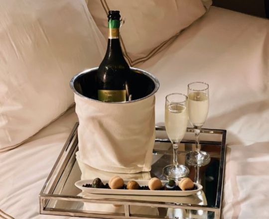 champagne and chocolates in bed