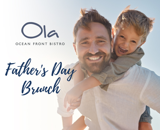 image of son seating on dad's shoulders looking at the ocean