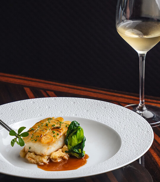 Fish with sauce and steamed vegetables