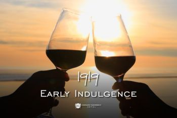 two wine glasses clinking at sunset with ocean views