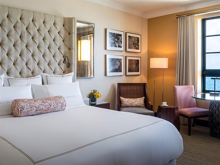 condado vanderbilt guest room bed and chairs