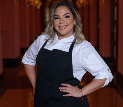 Nasha Fondeur in a white shirt and a black apron