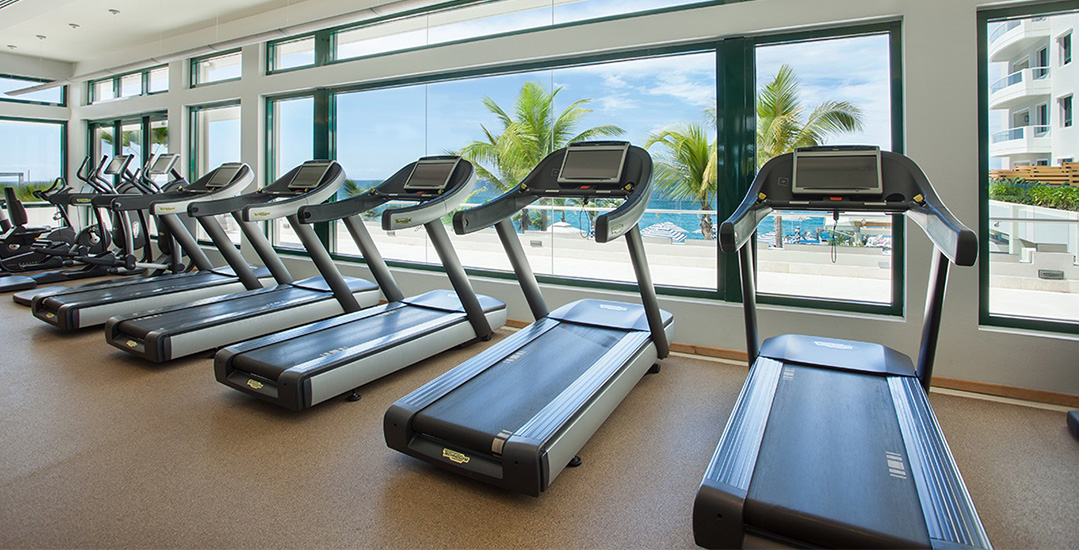 Two women exercise on treadmills enjoying the view | Condado Vanderbilt Hotel